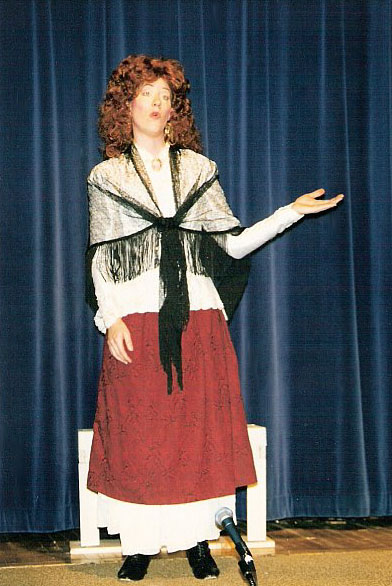 Lydia Puckett, a ghost who snubbed her civil war soldier boyfriend after she died. Singing...He's Gone Away from Spoon River.