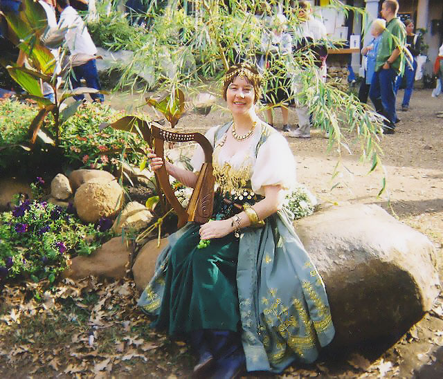 I learned to play a harp in later years. Here I am at the Renaissance Festival again singing with my Irish harp in 2005. 